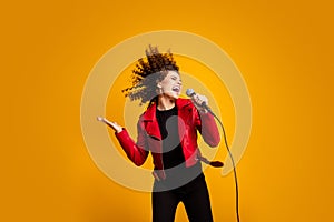 Portrait of attractive popular wavy-haired girl solist vocalist singing hit isolated on bright yellow color background photo