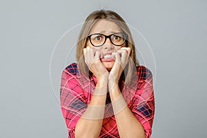 Portrait of attractive scared worried woman, biting nails