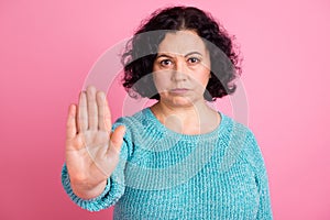 Portrait of attractive serious authority old woman showing palm stop sign isolated over pastel color background