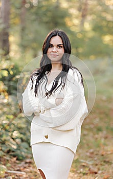 Portrait of attractive smiling caucasian brunette woman is looking in camera. The face of a happy and relaxing beautiful