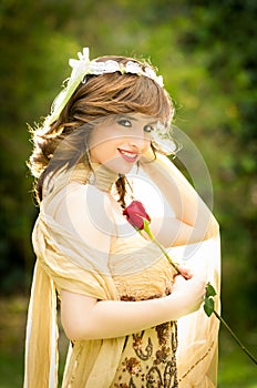 Portrait of attractive smiling woman with a rose