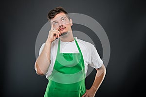 Portrait of attractive supermarket employer posing like thinking