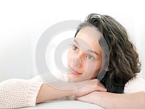 Portrait of an attractive thinking girl with curly hair