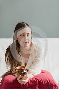 Portrait of an attractive thirty year old girl on her couch in the morning