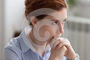 Portrait of attractive thoughtful businesswoman planning, thinking about solving problem