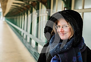 Portrait of an attractive white woman , 30 years old with winter clothes on a windy day at the seaside, Blankenberge