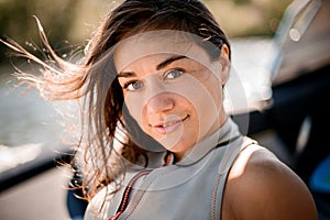 Portrait of attractive woman with brown hair developing in the wind