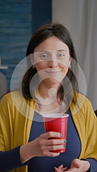 Portrait of attractive woman drinking beer during celebration wekeend