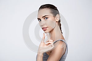 Portrait of attractive woman holding pills