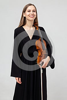 Portrait of attractive woman musician playing violin