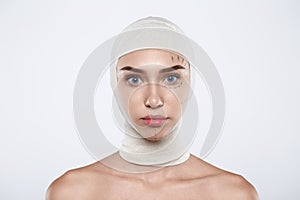 Portrait of attractive woman with plastic surgery and bandage