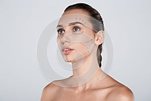 Portrait of attractive woman with plastic surgery dashed line