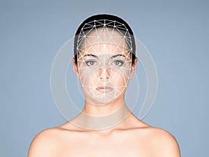 Portrait of attractive woman with a scnanning grid on her face. Face id, security, facial recognition concept.