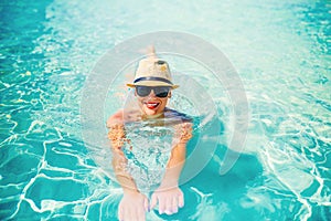 portrait of attractive woman sunbathing and smiling at camera. Summer beach holiday, pool details