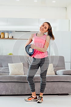 Portrait of an attractive woman wearing a blue jogging or fitness kit after work at home or at the club.