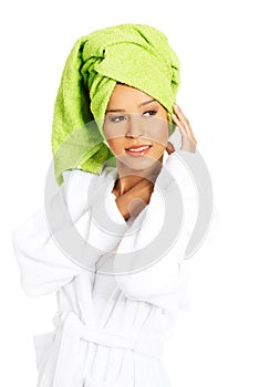 Portrait of attractive woman wrapped in towel with turban on head.