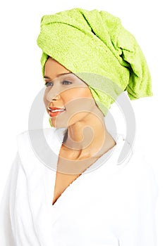 Portrait of attractive woman wrapped in towel with turban on head.