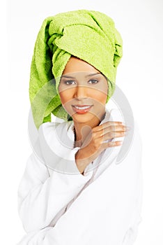 Portrait of attractive woman wrapped in towel with turban on head.