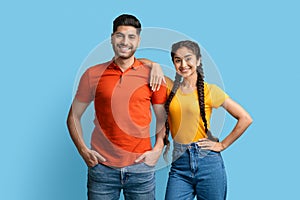 Portrait Of Attractive Young Arab Man And Woman Posing Over Blue Background,