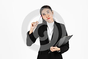 Portrait of attractive young Asian business woman holding pen and having idea posing over white isolated background