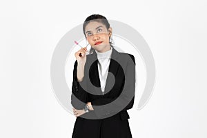 Portrait of attractive young Asian business woman holding pen and having idea posing over white isolated background