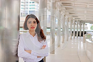 Portrait of attractive young Asian businesswoman looking confident posing outside on urban background. Leadership woman concept.