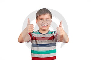 Portrait of attractive young boy, smiling showing thumbs up, on white background. Copy space