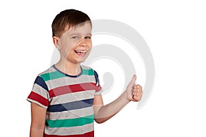 Portrait of attractive young boy, smiling showing thumbs up, on white background. Copy space