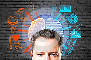 Portrait of attractive young european businessman with creative brain sketch with creative and analytical side on brick background
