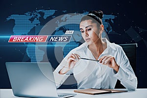 Portrait of attractive young european woman at desktop with laptop on blurry blue breaking news pattern background. Headline,