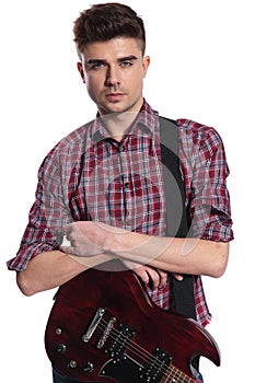 Portrait of attractive young guitarist wearing shirt with red pl