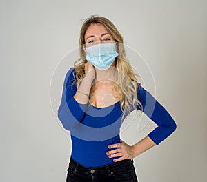 Portrait of attractive young happy woman with protective face mask isolated on neutral background