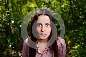 Portrait of attractive young indecisive shy woman face close up