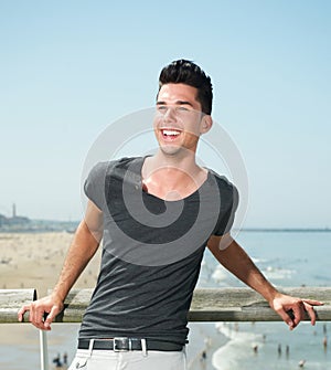Portrait of an attractive young man smiling at the beach