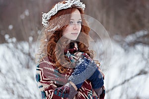 Portrait of attractive young redheaded woman in a white wreath