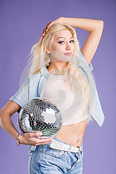 Portrait of attractive young woman with disco ball