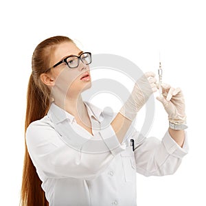 Portrait of an attractive young woman doctor with a syringe in h