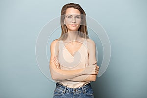 Portrait attractive young woman in glasses with arms crossed