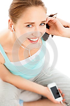 Portrait of attractive young woman listening to music at gym