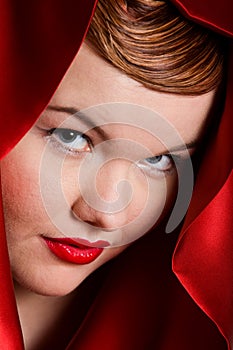 Portrait of attractive young woman in red hood