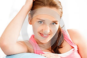 Portrait of attractive young woman relaxing fitness ball at gym