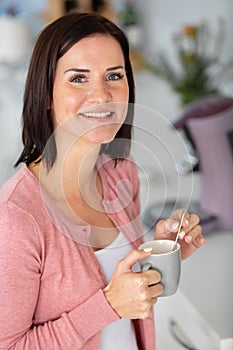 portrait attractive young womanholding cup
