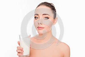 Portrait of attrective young woman holding glass of milk coktail