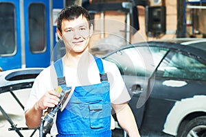 Portrait of auto mechanic worker with power polisher machine photo