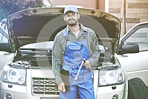 Portrait of auto mechanic working with wrench