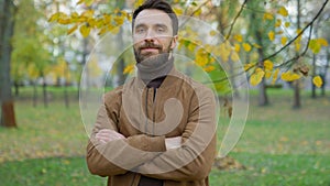 Portrait in autumn park outdoors city nature confident friendly happy Caucasian millennial 30s man guy father male