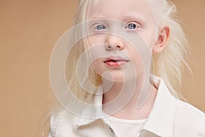 Awesome albino kid with blonde hair, isolated photo