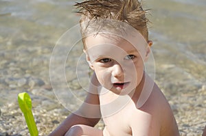 Portrait of a baby boy playing by the sea