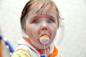 Portrait baby boy with toy ball in mouth