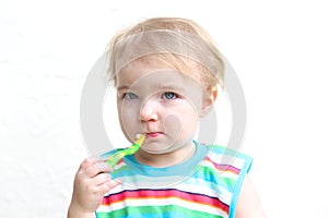 Portrait of baby eating porridge with spoon